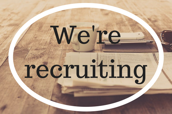 Circle above newspapers with 'we're-recruiting' written inside